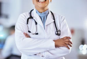 Why Choose Primary Care. A closeup doctor with crossed arms