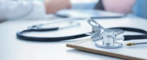 Closeup of a stethoscope on a table, highlighting the importance of Primary Care for comprehensive and personalized health solutions.