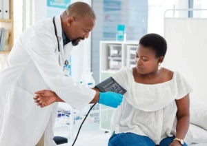 Choose Wellness Programs: Nurse taking patient's blood pressure in a healthcare setting